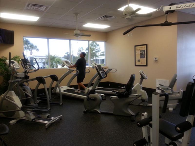 Fitness center with stationary bike, elliptical, treadmill, and other fitness equipment.